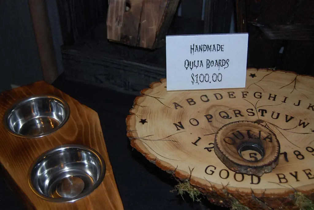 Handmade ouija board and coffin-themed pet dishes