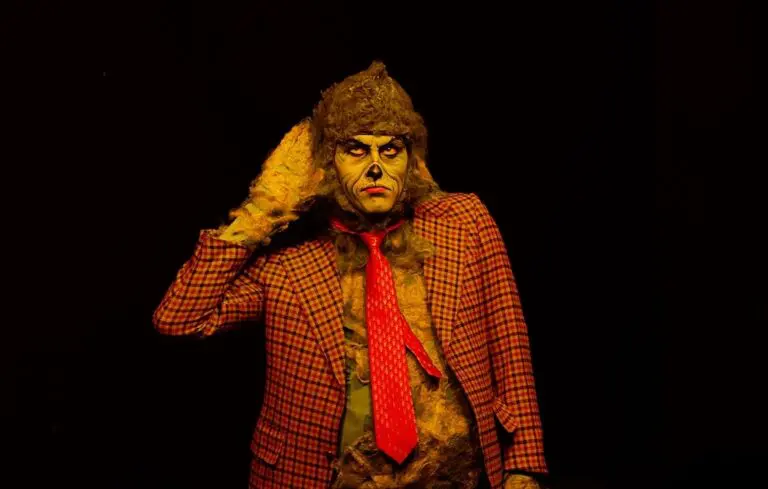 Grinch holds hand to ear