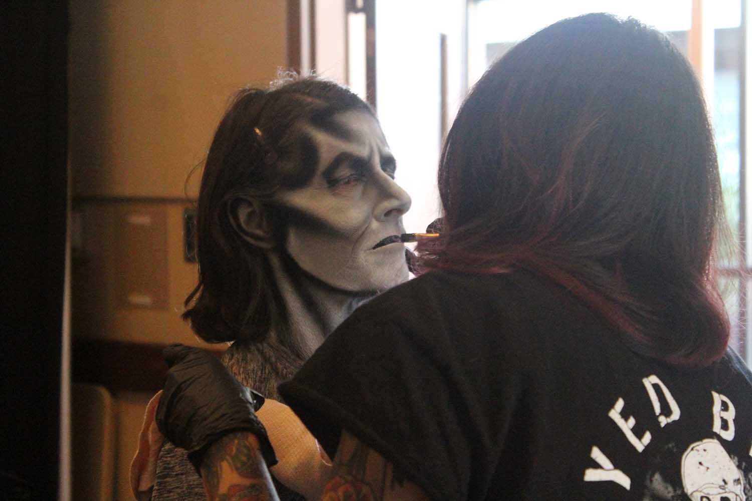 Woman getting a monster makeup makeover